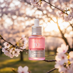 Anua Niacinamide Serum with cherry blossom background